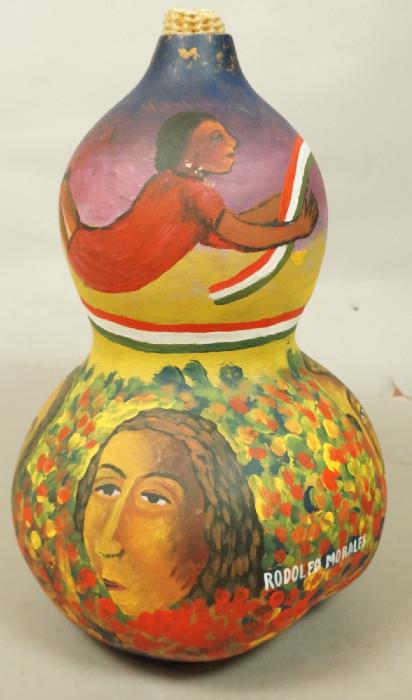 Lot 269  -  RODOLFO MORALES Hand Painted Gourd. Mexican. Portraits of Women amongst Flowers. Mexican Flag Banner. Corn Cob Stopper. Signed. -- Dimensions:  H: 13 inches: W: 8 inches --- 