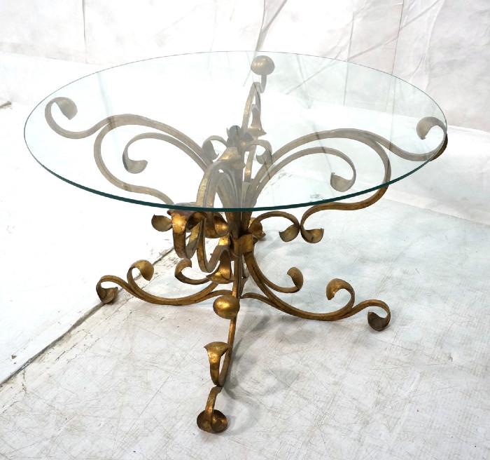 Lot 297  -  Fancy Gilt Iron Glass Top Side Table. Corseted form with decorative scrolls. Thin glass top. -- Dimensions:  H: 17.25 inches: W: 26.5 inches --- 