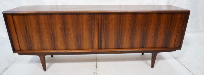 Lot 300  -  Danish Rosewood BERNARD & SONS Two Tambour Door Credenza Sideboard Cabinet. Raised on legs with skirt. Fitted interior. Paper label. -- Dimensions:  H: 31.25 inches: D: 20 inches: L: 83 inches --- 