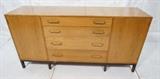 Lot 304  -  DUNBAR Sideboard Credenza. Two tone with dark stained base. Brass Pulls. Four drawers & two side compartments. Dunbar rectangle metal tag.-- Dimensions:  H: 33.25 inches: D: 19 inches: L: 66.25 inches --- 