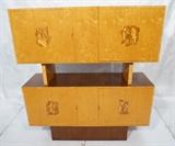 Lot 306  -  Italian Art Deco Two Part Cabinet. Four Inlaid Images of the Arts. Burled Maple with Dark Mahogany Trim & Accents. Four doors. -- Dimensions:  H: 66 inches: D: 18 inches: L: 60 inches --- 