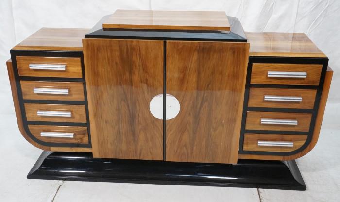 Lot 312  -  Art Deco Sideboard Buffet.  High polish wood and black lacquer.  Chrome pulls and front plate.  Flared base.  Has key.-- Dimensions:  H: 39.5 inches: W: 69.5 inches: D: 19.5 inches --- 