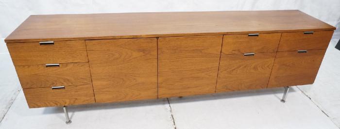 Lot 370  -  Robert John Credenza Sideboard.  Long form on knoll style metal legs.  2 doors an 7 drawers.  American modern walnut.  Door folds and slides.-- Dimensions:  H: 26.25 inches: W: 85.25 inches: D: 18.25 inches --- 