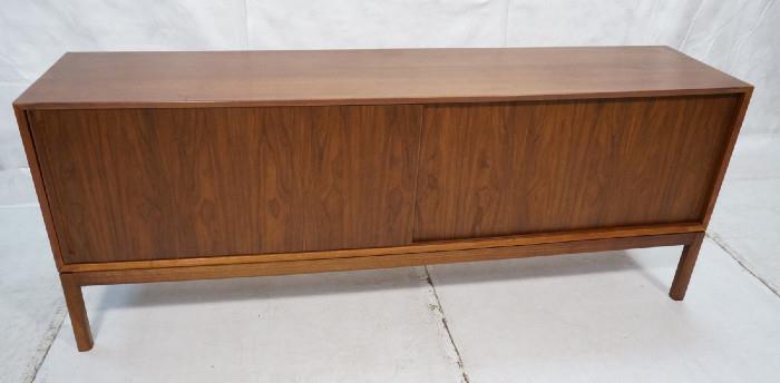 Lot 378  -  Danish Modern Teak Long Sideboard Credenza. Two sliding doors. Beveled edge. Raised on legs. Finished Back. Recessed pulls. Interior fitted with drawers & shelves.-- Dimensions:  H: 31 inches: D: 18.75 inches: L: 79 inches --- 