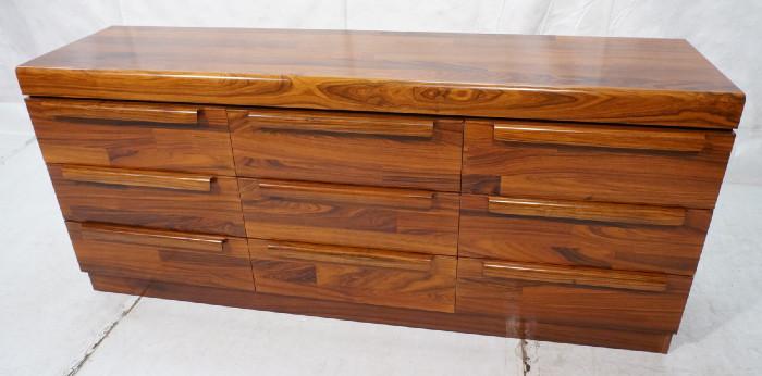 Lot 392  -  Modernist Rosewood Chest Dresser. Rosewood veneer is in 3" pieced strips. Long horizontal wood pulls. Nine Drawers. -- Dimensions:  H: 31.5 inches: D: 20 inches: L: 71 inches --- 