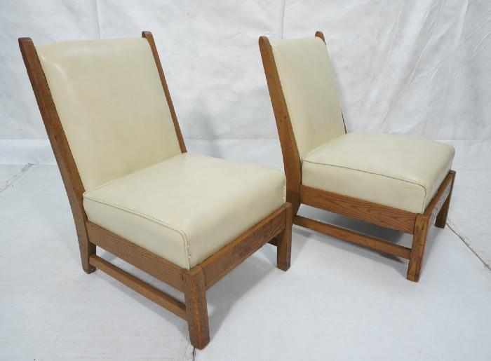 Lot 404  -  Pair Oak Armless Lounge Chairs.  Off white vinyl upholstery on oak frames.-- Dimensions:  H: 35.5 inches: W: 22 inches: D: 25 inches --- 