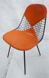 Lot 433  -  CHARLES EAMES for HERMAN MILLER Bikini Chair. Orange Bikini cushions. Label-- Dimensions:  H: 32.25 inches: W: 19 inches: D: 21 inches --- 