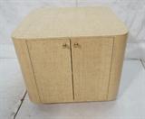 Lot 475  -  SPRINGER style Grass Cloth Covered Table Cabinet. Two doors with brass pulls. White interior. -- Dimensions:  H: 26 inches: W: 30.25 inches: D: 31.25 inches --- 