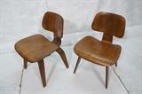 Lot 490  -  Pr Charles EAMES for HERMAN MILLER DCW Chairs. Stamped DCW. One has foil label.-- Dimensions:  H: 29 inches: W: 19.5 inches: D: 21 inches --- 