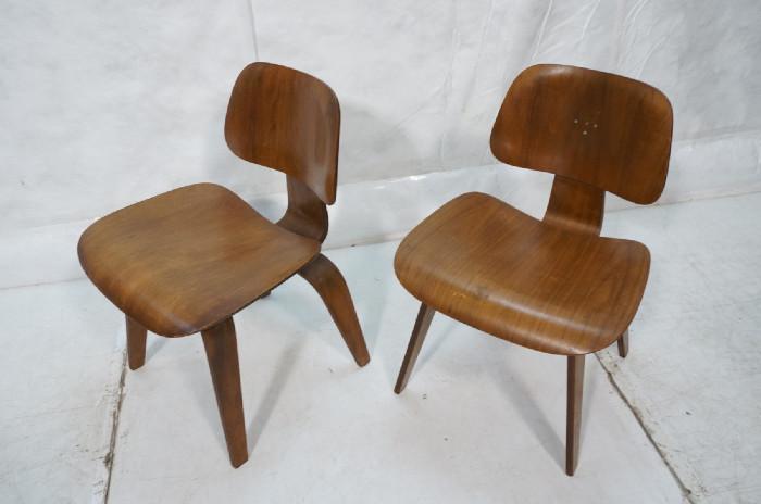 Lot 490  -  Pr Charles EAMES for HERMAN MILLER DCW Chairs. Stamped DCW. One has foil label.-- Dimensions:  H: 29 inches: W: 19.5 inches: D: 21 inches --- 