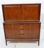 Lot 491  -  American Modern Gentleman's Chest Dresser. Two doors over three drawers. Wood pulls-- Dimensions:  H: 51 inches: W: 42 inches: D: 19 inches --- 