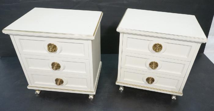 Lot 515  -  Pr Cream Lacquered 3 Drawer Night Stands. Regency style with paneled drawers and large brass pulls. Metal legs. Gold metal trim-- Dimensions:  H: 24.5 inches: W: 23 inches: D: 18 inches --- 