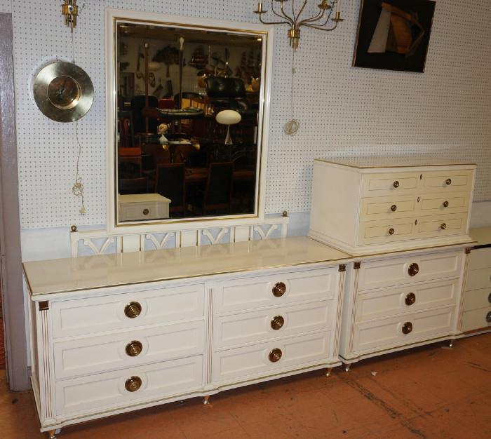 Lot 516  -  5pc Cream Lacquered Bedroom Furniture. High & Low Dresser. Mirror. Head & Footboard with wood rails. Regency style with paneled drawers and large brass pulls. Brass Column & Capital Details. Metal legs.-- Dimensions:  H: 52.5 inches: W: 42.25 inches: D: 21.5 inches --- 