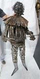 Lot 253  -  Metal Brutalist Figural Sculpture. Man with ruffled collar playing mandolin. -- Dimensions:  H: 63 inches: W: 27 inches: D: 17 inches --- 