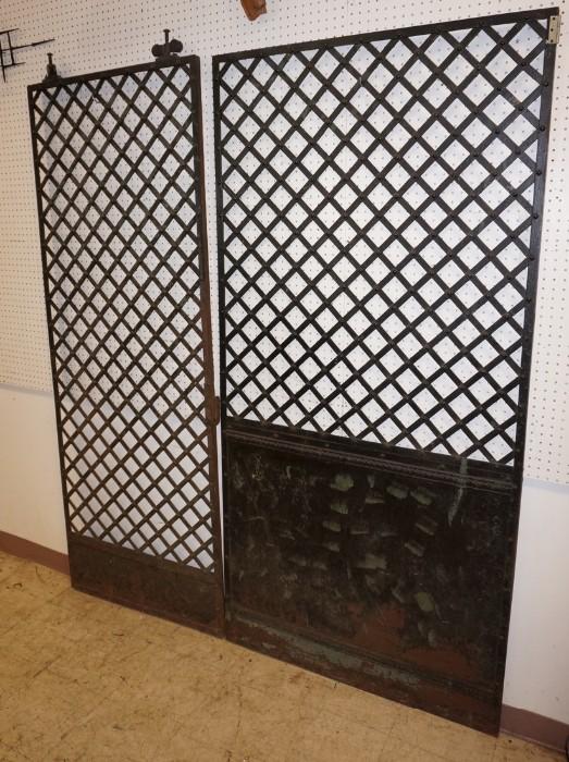 Lot 550  -  2pc Iron Lattice Panels. Painted black. One panel with attached rollers. Panels are different design and different sizes-- Dimensions:  H: 84 inches: W: 40 inches --- 
