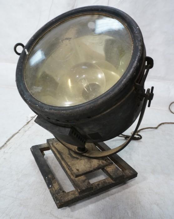 Lot 559  -  Industrial Heavy Metal Spot Light. Light pivots on rolling base.-- Dimensions:  H: 22 inches: W: 12 inches: D: 12 inches --- 