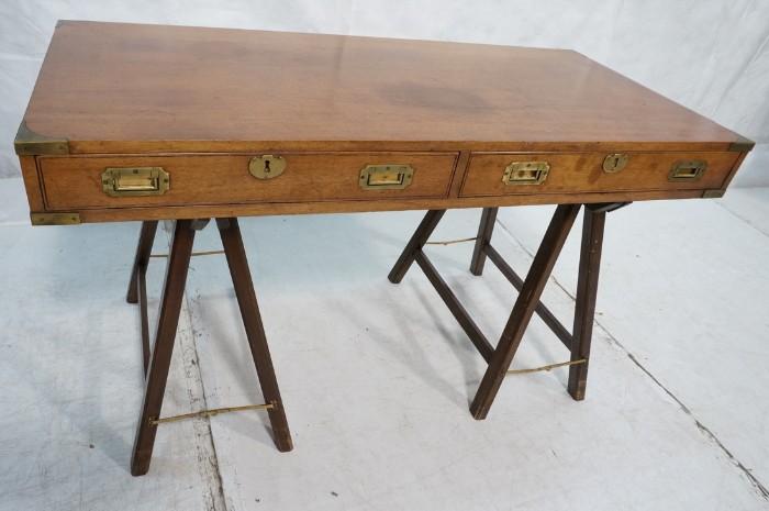Lot 562  -  American Modern Campaign style Wood Desk. Brass hardware and pulls. "A" Frame bases with collapsible brass stretchers. -- Dimensions:  H: 29 inches: W: 51 inches: D: 24 inches --- 