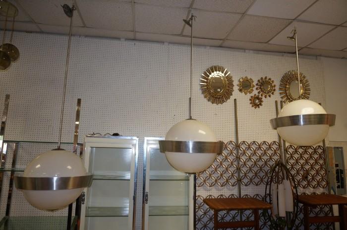 Lot 565  -  3pc Large Hanging Ball Pendant Lights. Large white plastic sphere shades with pierced aluminum rings. Hanging rods are three different lengths. -- Dimensions:   --- 