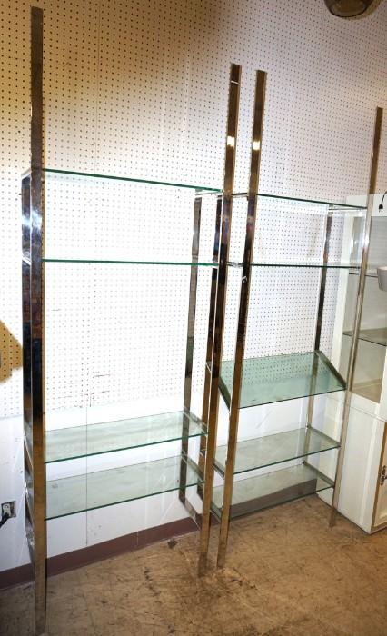 Lot 566  -  Pr Chrome & Glass Wall Shelf Units. Flat chrome uprights. Thick glass.-- Dimensions:  H: 95 inches: W: 32 inches: D: 12 inches --- 