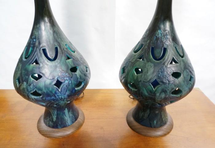 Lot 572  -  Pr Modernist Pottery Lamps. Bulbous form with pierced design. Wood grain metal base. Period shades.-- Dimensions:  H: 40 inches: W: 13 inches --- 