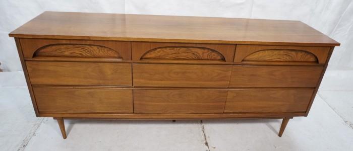 Lot 576  -  Nine Drawer Walnut American Modern Dresser Chest. Rosewood highlights. Raised on legs-- Dimensions:  H: 31 inches: D: 18.25 inches: L: 73 inches --- 