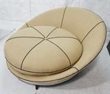 Lot 584  -  MILO BAUGHMAN style Oversized Lounge Chair. Upholstered in beige fabric with black trim. Ebonized Peg legs. -- Dimensions:  H: 30 inches: W: 54 inches: D: 58 inches --- 