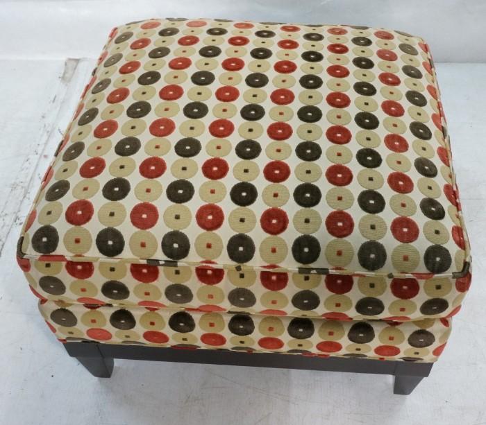 Lot 587  -  DONGHIA Upholstered Ottoman Stool. Fabric with flocked circle design. Wood skirt with tapered legs. Marked Donghia. -- Dimensions:  H: 17 inches: W: 23 inches: D: 25 inches --- 