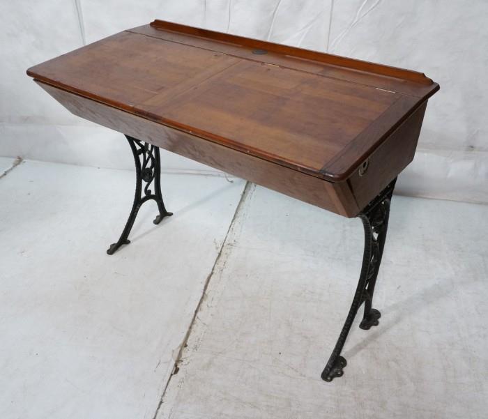 Lot 593  -  Industrial Wood Desk with Iron Base. Two part flip top. Bloomsburg University metal tag.-- Dimensions:  H: 31 inches: W: 42 inches: D: 21 inches --- 