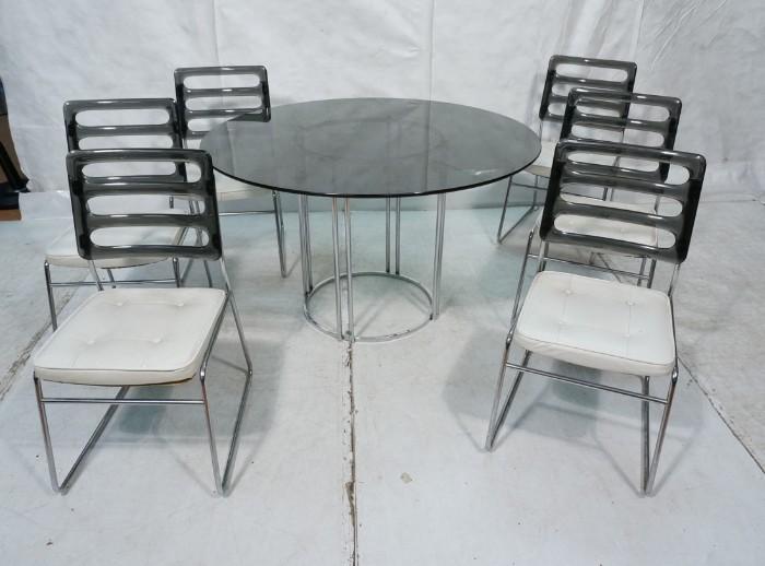 Lot 612  -  70's Modern Dining Table. 6 Chairs. Chrome Tubular Frame with Round Smoked Glass Top.  Six Chairs with smoked acrylic backs and white leather seats. -- Dimensions:  H: 29 inches: W: 47 inches --- 