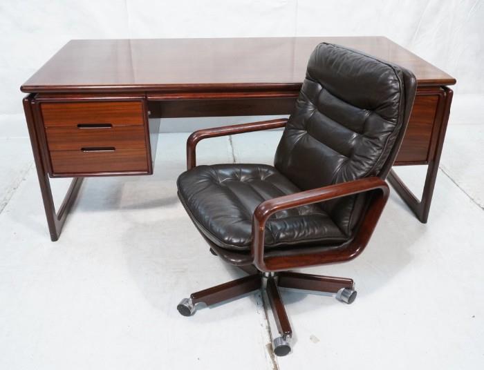 Lot 621  -  DYRLUND Danish Rosewood Desk & Office Chair. Four drawers. Rosewood Chair with Chocolate Leather Upholstery. Desk & chair both marked Dyrlund. -- Dimensions:  H: 29 inches: D: 35 inches: L: 70 inches --- 