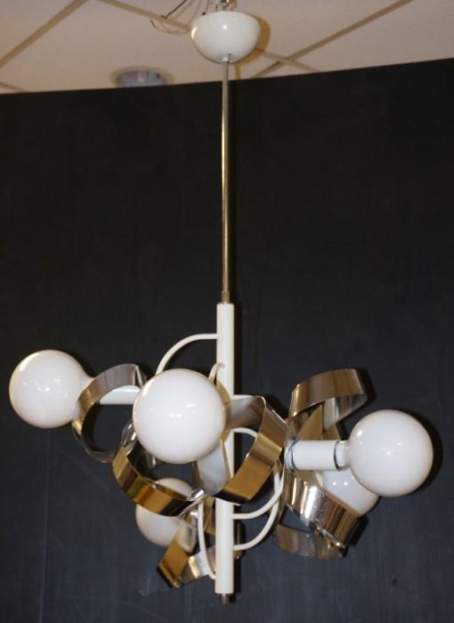 Lot 624  -  70's Modern Hanging Chrome Chandelier. Flat Chrome Ribbons with 5 White Glass Shades. White paint accents.-- Dimensions:  H: 37 inches: W: 26 inches: D: 26 inches --- 