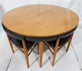 Lot 631  -  Round Hans Olsen style Dining Table with Four Nesting Dining Chairs. Black vinyl seats, chair backs and table skirt. Four legged chairs. Not marked-- Dimensions:   --- 