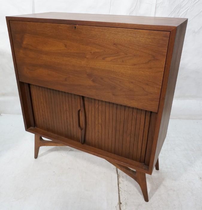 Lot 633  -  American Modern Drop Front Desk Cabinet. Lower sliding doors. Raised on shaped legs. -- Dimensions:  H: 41 inches: W: 36 inches: D: 16 inches --- 