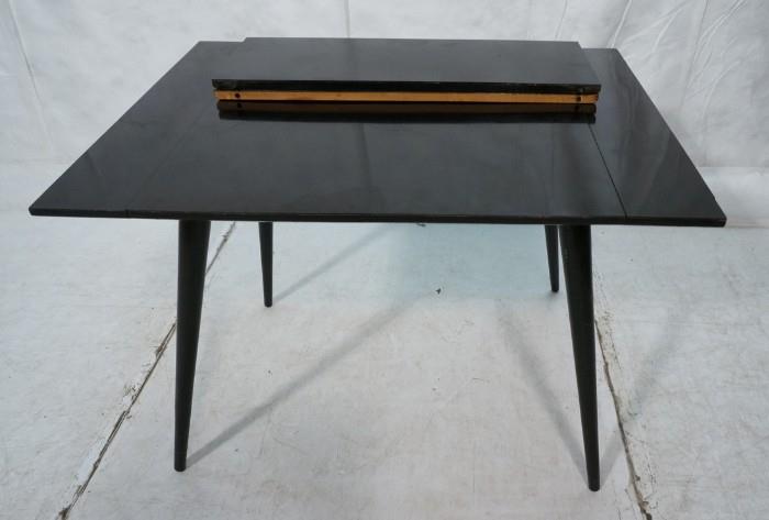 Lot 647  -  Black Lacquer PAUL McCOBB Table. Two pull out edges for 92) 10" leaves. Marked.-- Dimensions:  H: 28 inches: W: 29.5 inches: D: 40 inches --- 