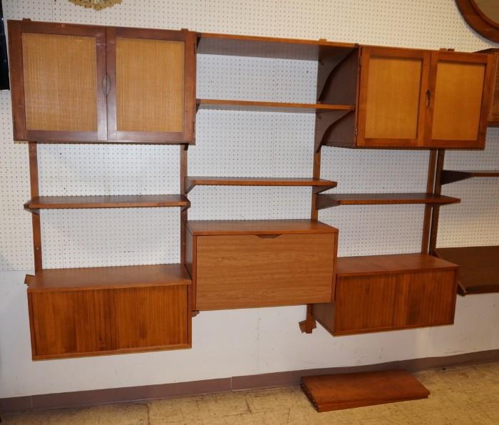 Lot 650  -  Modernist Wall Unit with drop down desk. (2) two door woven front cabinets. (2) two sliding door cabinets.-- Dimensions:  H: 83 inches: D: 14 inches: L: 96 inches --- 