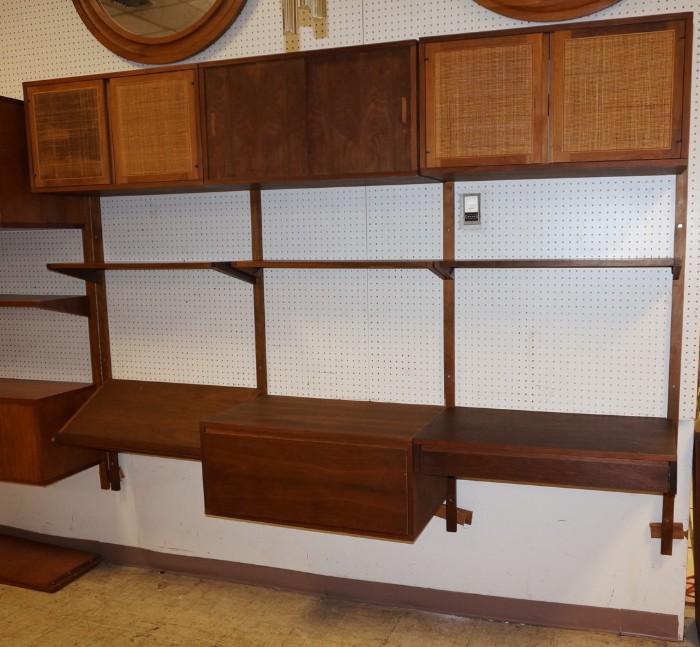 Lot 654  -  Modernist Wall Unit with drop down desk. (2) Drawers. (1) Slant Shelf (2) cabinets with doors (1) Cabinet with sliding doors.-- Dimensions:  H: 85 inches: D: 18 inches: L: 98 inches --- 
