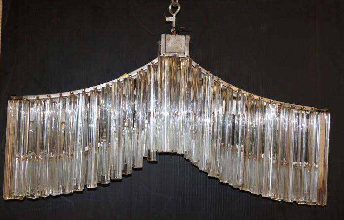 Lot 656  -  Chevron Form CAMER Hanging Prism Chandelier. Venini style Three sided prisms. Marked CAMER.-- Dimensions:  H: 23 inches: W: 37 inches: D: 9 inches --- 