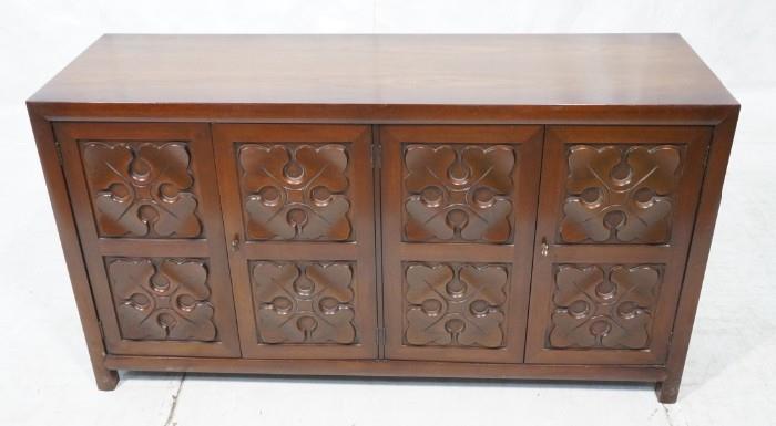 Lot 712  -  BAKER Four Door Cabinet Credenza. Four Doors with Carved Quatrefoil details. Raised on legs. Metal tag-- Dimensions:  H: 31.75 inches: W: 58 inches: D: 19 inches --- 