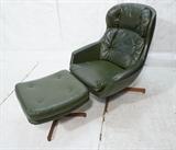 Lot 749  -  Green Vinyl SELIG Lounge Chair & Ottoman. Metal rod with wood feet. Selig label.-- Dimensions:  H: 37.75 inches: W: 32 inches: D: 25 inches --- 