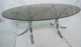 Lot 750  -  70's Modern Chrome & Glass Dining Table. Oval Smoked Glass on chrome base.-- Dimensions:  H: 28.75 inches: W: 74.5 inches: D: 42.5 inches --- 