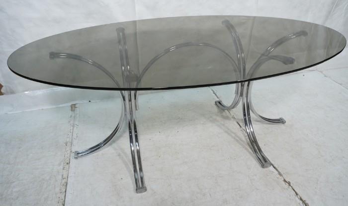 Lot 750  -  70's Modern Chrome & Glass Dining Table. Oval Smoked Glass on chrome base.-- Dimensions:  H: 28.75 inches: W: 74.5 inches: D: 42.5 inches --- 
