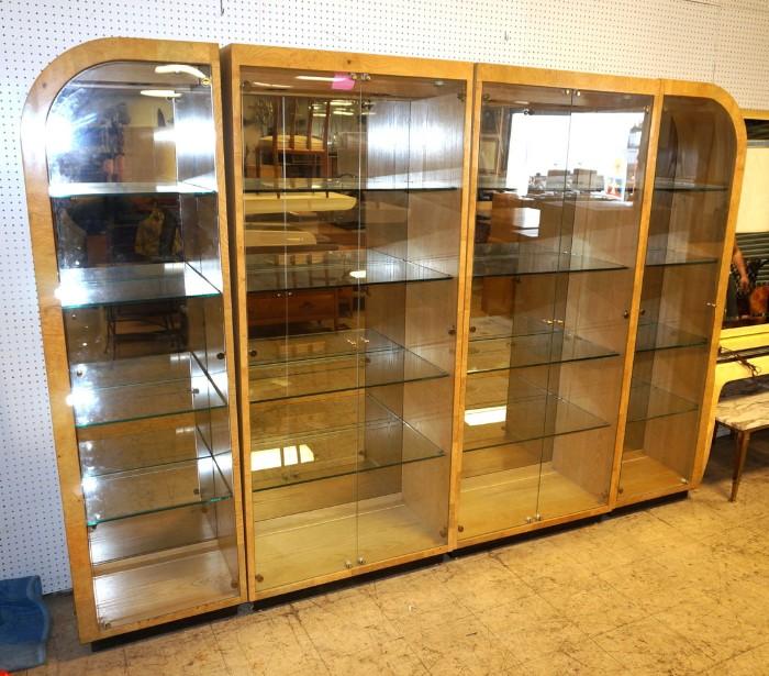 Lot 790  -  Four Section Burled Wood Wall Unit. Henredon Two curved top end sections. Glass doors. Interior shelves. All sections light. -- Dimensions:  H: 79.5 inches --- 