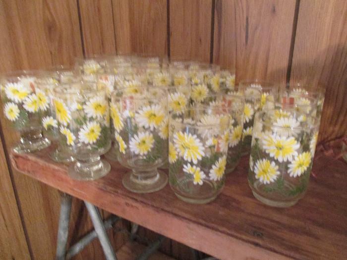 A set of retro 1960's tumblers (glasses), both flat bottom and footed.   They have a enamel daisy pattern and they each have an original price label from Gibson's Discount Store.   Do you remember Gibson's? 