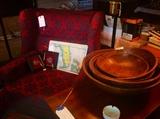 Wingback chair and collection of wooden dough bowls.