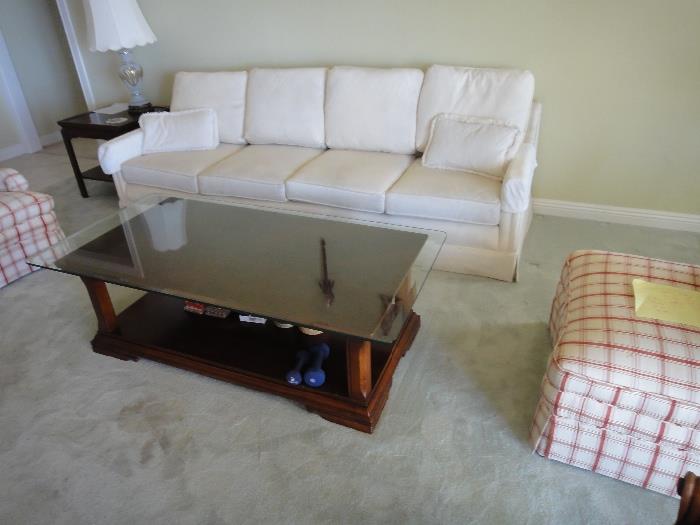 Nice 4 cushion couch. Large wooden coffee table with glass top. quite heavy
