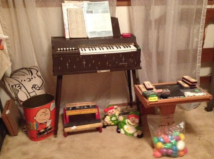 Misc vintage 1960s toys, Magnus Child's organ, Charlie Brown metal Trash Can, 1960s step stool, 1964 Ride-on train, Board Games, Easter Eggs, 1960s lift top Child's desk, chalk, erasers, Raggedy Ann & Andy Ceramic figures