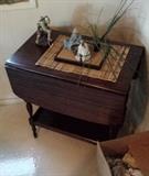 Rolling tea cart, two sided and lower shelf unit. Collectible Asian Figurines.