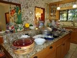 Huge kitchen: cupboards filled with collectors tea cups, saucers & plates