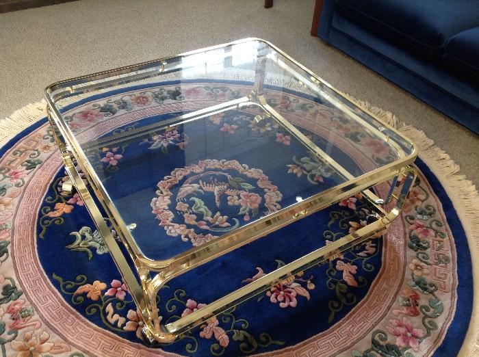 Round Persian style rug, gold and glass coffee table