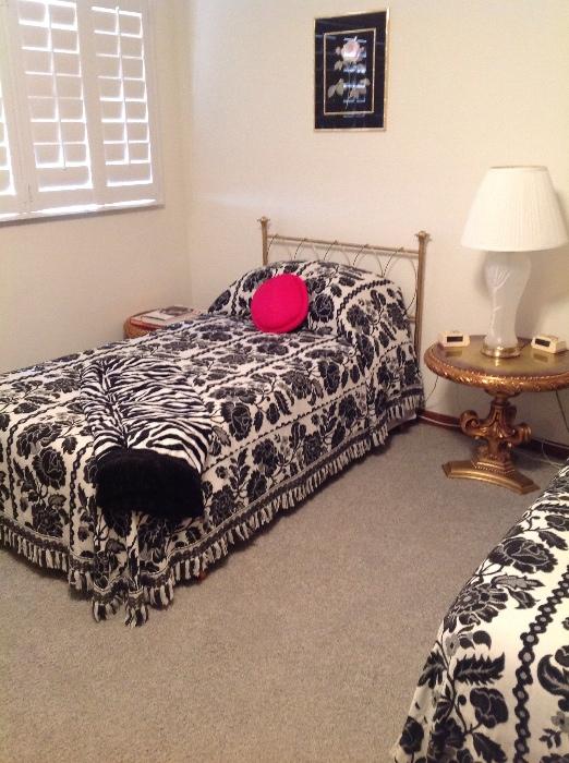 Black and white bedding,gold twin headboard set of two.  Gold side table, glass lamp, Hollywood Regency